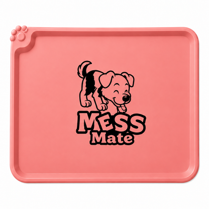 A pink rectangular dog training mat with rounded corners, featuring a black cartoon puppy graphic and the words 'MESS Mate' printed in the center. The mat has raised edges and a paw print molded into the top-left corner, shown against a plain white background.